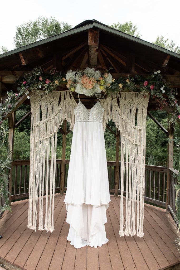 wedding dress hanging with flowers