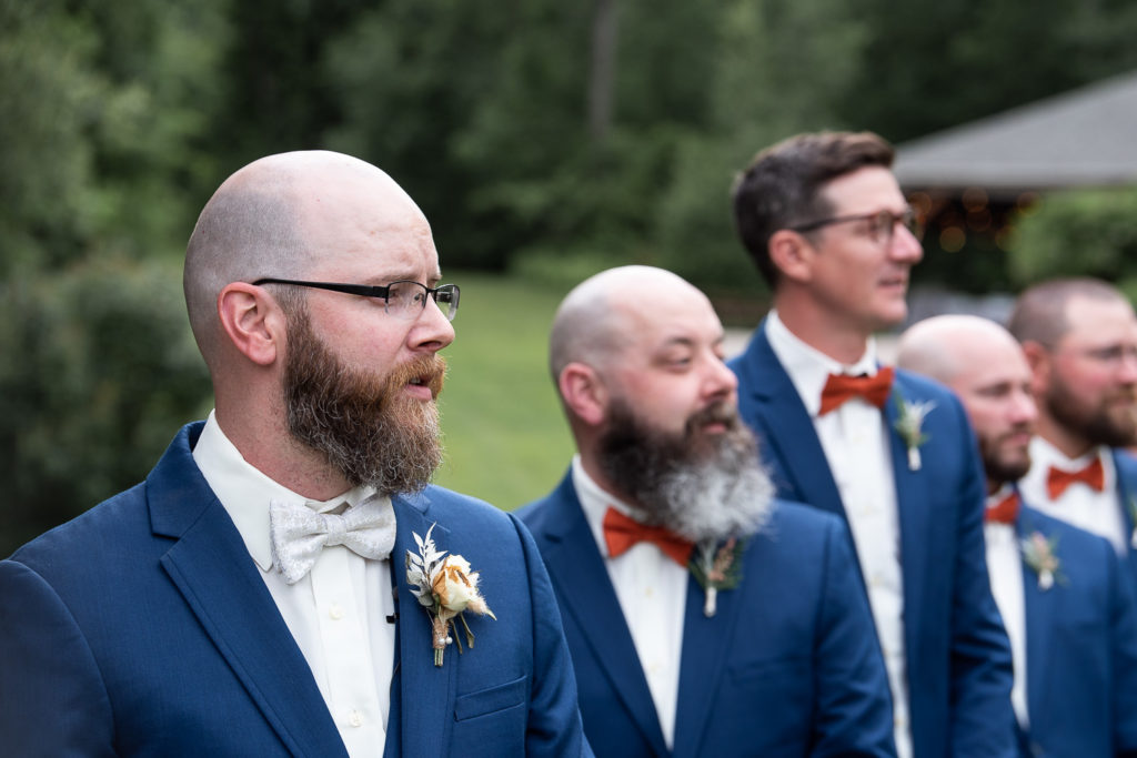 groom watching bride walking down aisle