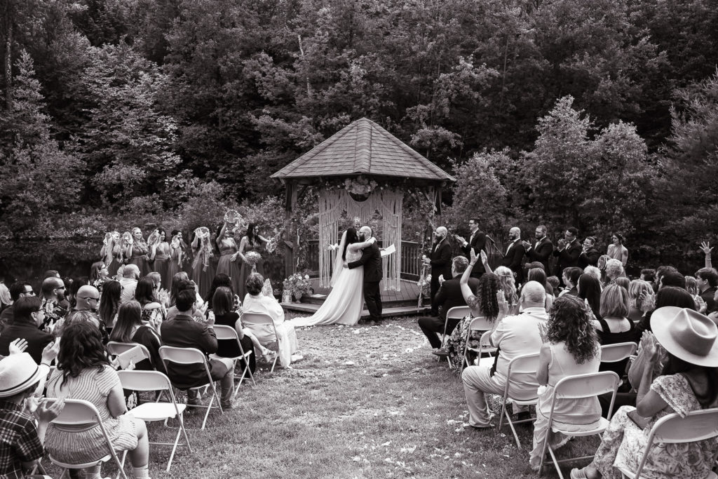 bride and groom kissing durign wedding ceremony